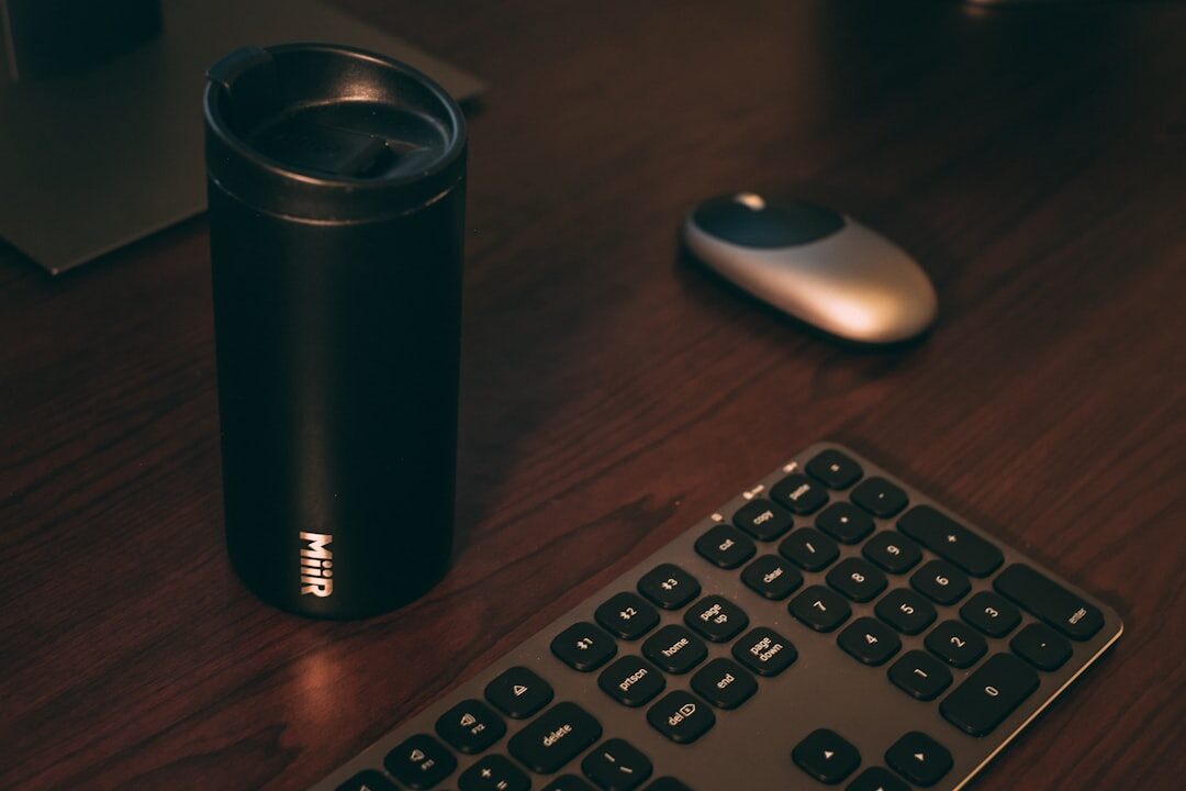 Desk with camera, notebook and coffee cup
