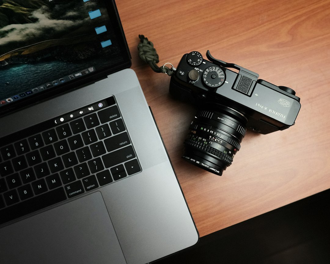 Photographer editing photos on a laptop